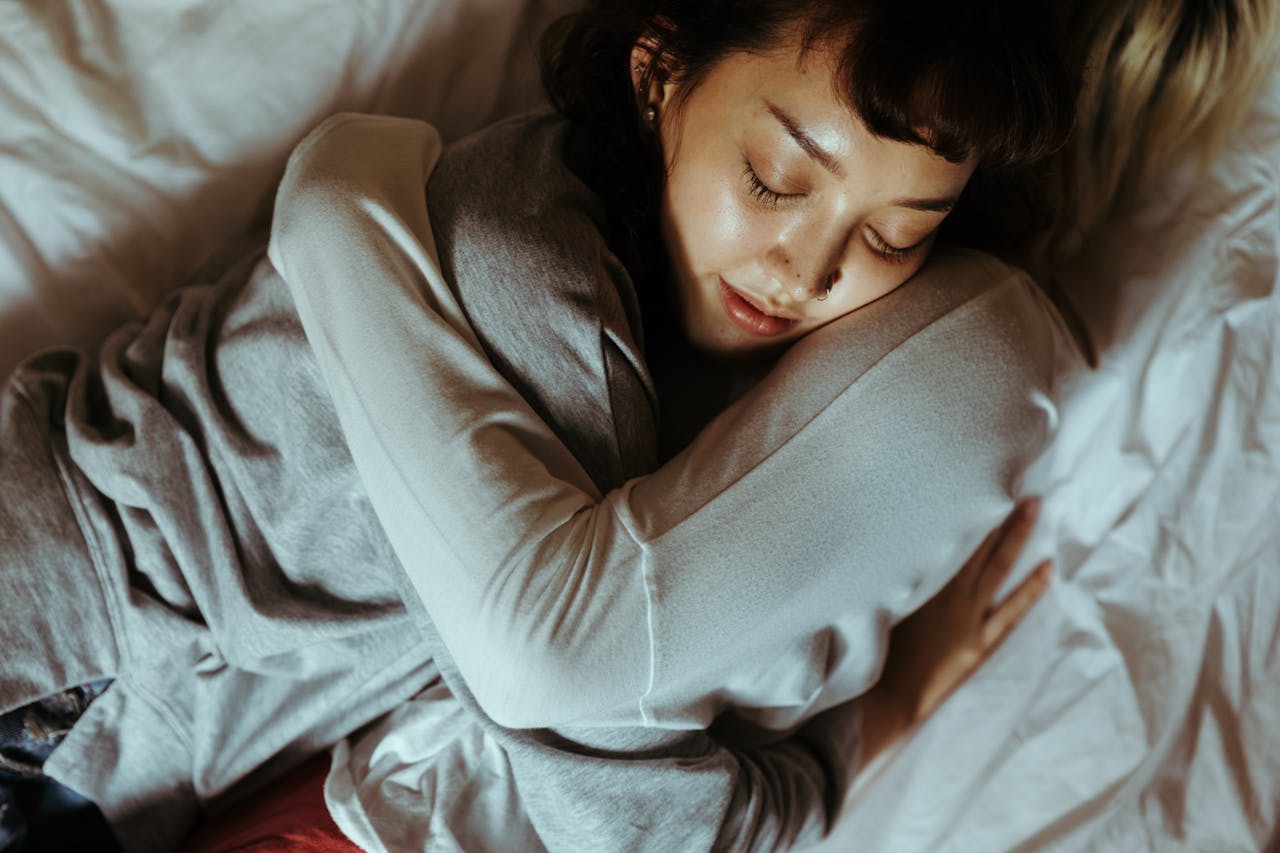 A relaxing moment of affection and tranquility shared by a couple embracing in bed.
